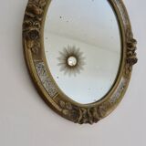 Oval wall mirror, golden floral pattern in stucco and wood, late 19th century