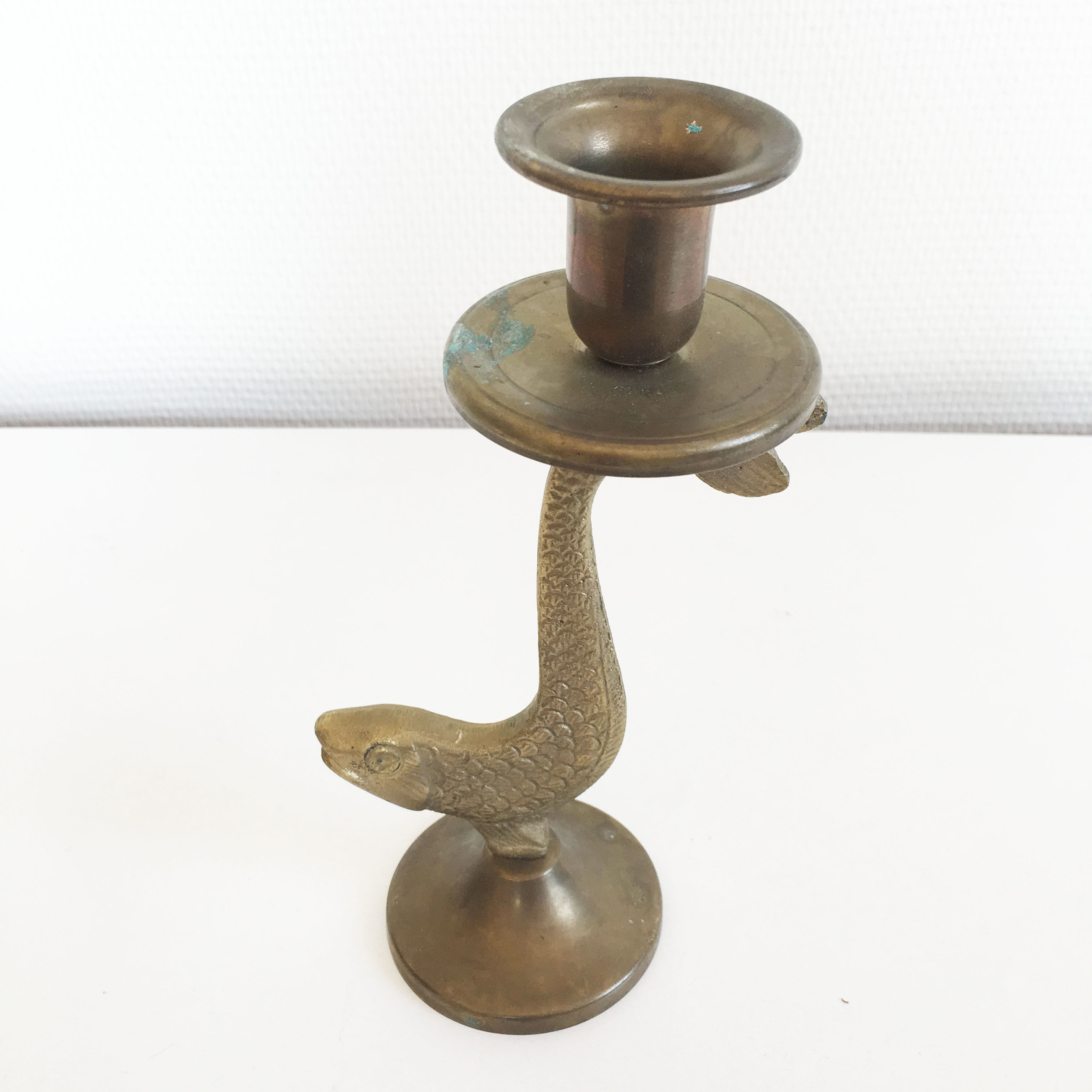 Old golden brass fish candlestick