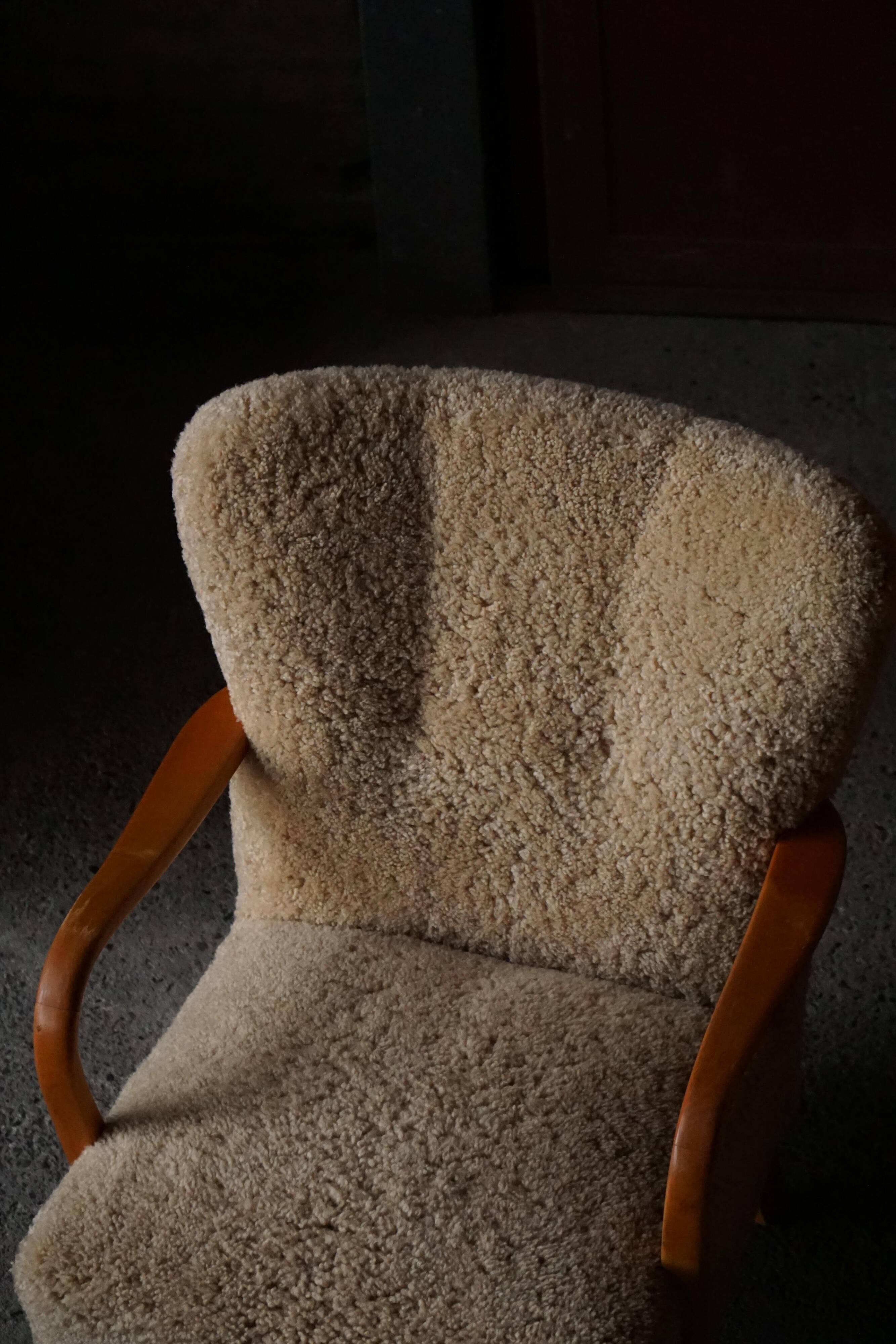 Pair of Mid Century Modern Swedish lounge chairs in birch and lamb's wool, 1960s.