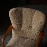 Pair of Mid Century Modern Swedish lounge chairs in birch and lamb's wool, 1960s.