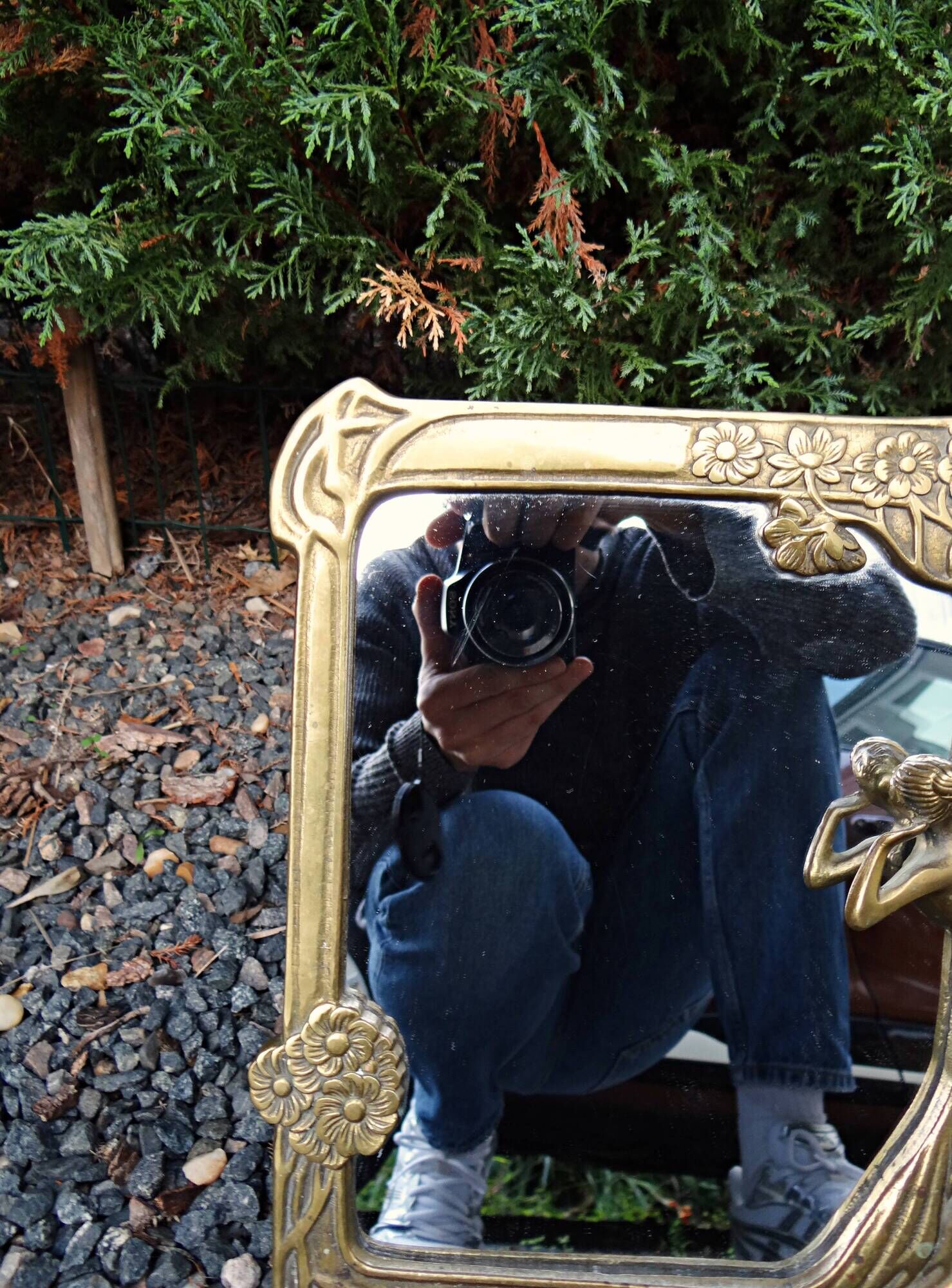 Art Nouveau mirror in gilded brass with a woman figure emerging from a vintage frame