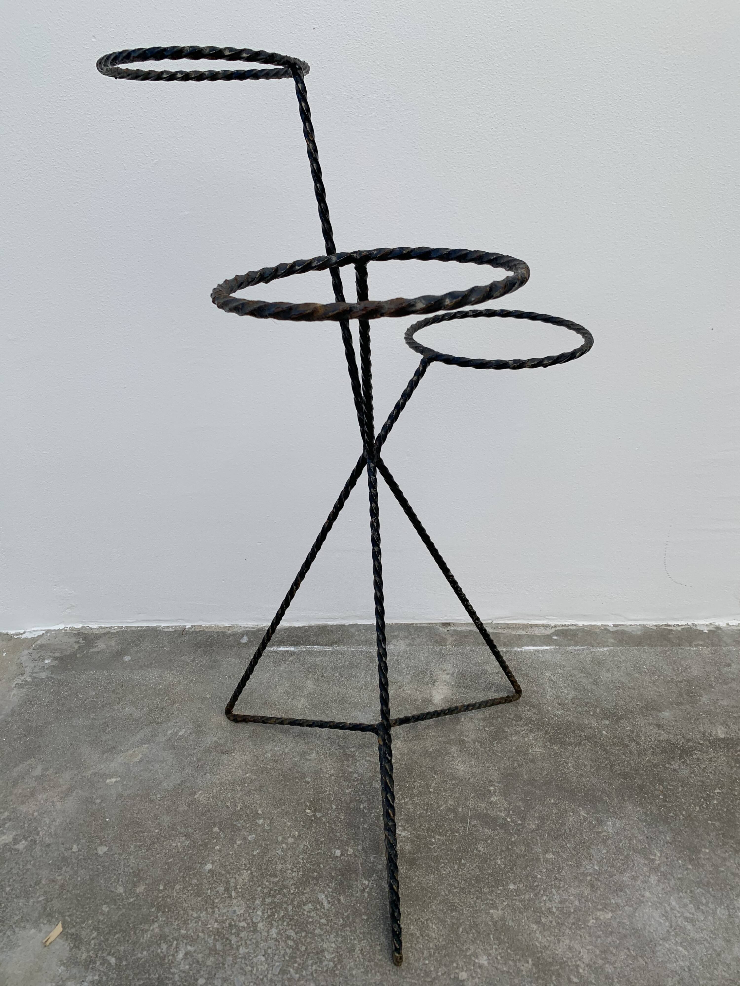 Black metal tripod plant holder