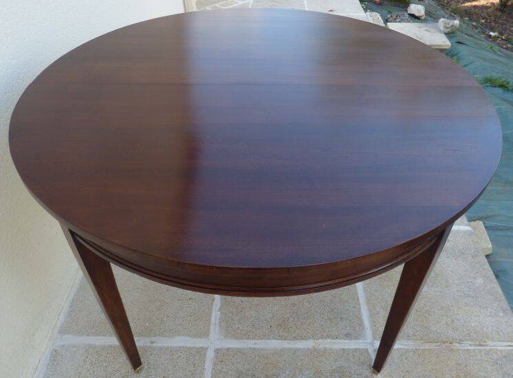 Round mahogany table with mahogany veneer and brass sabot foot.