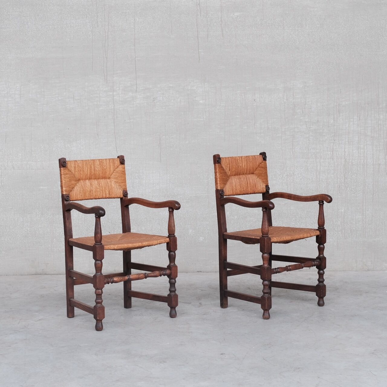Pair of mid-century oak and rush french armchairs