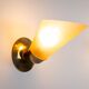 Set of three brass sconces with decorated yellow glass shades