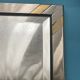 Faceted modernist wall mirror in steel and brass, geometric mixed metal frame 1970s.