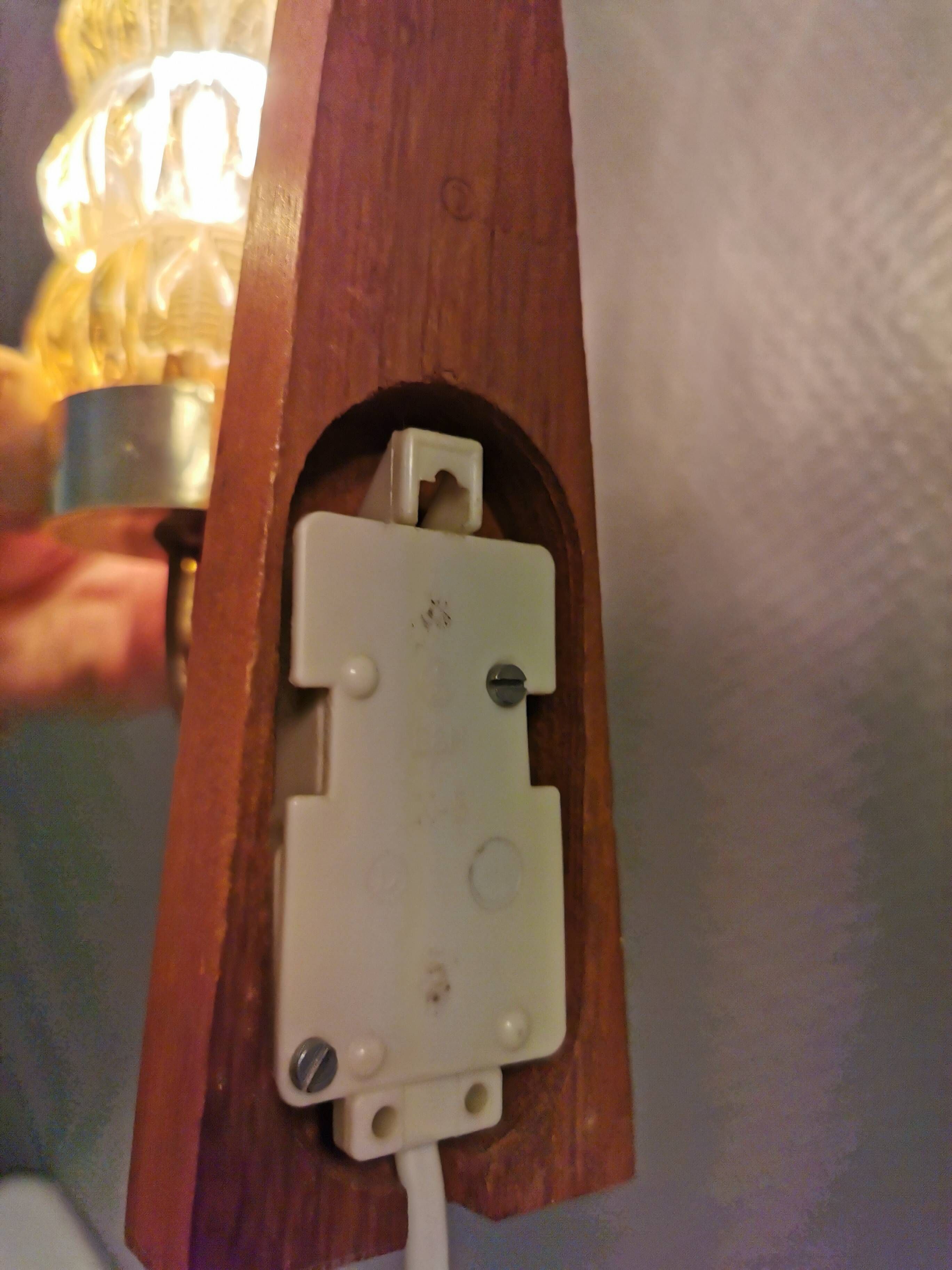 A set of Danish wall lights in champagne coloured glass with brass and teak.