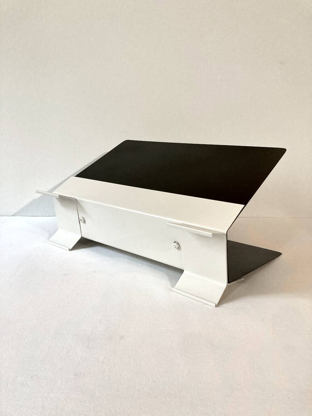 Black and cream metal magazine rack, 1950s.