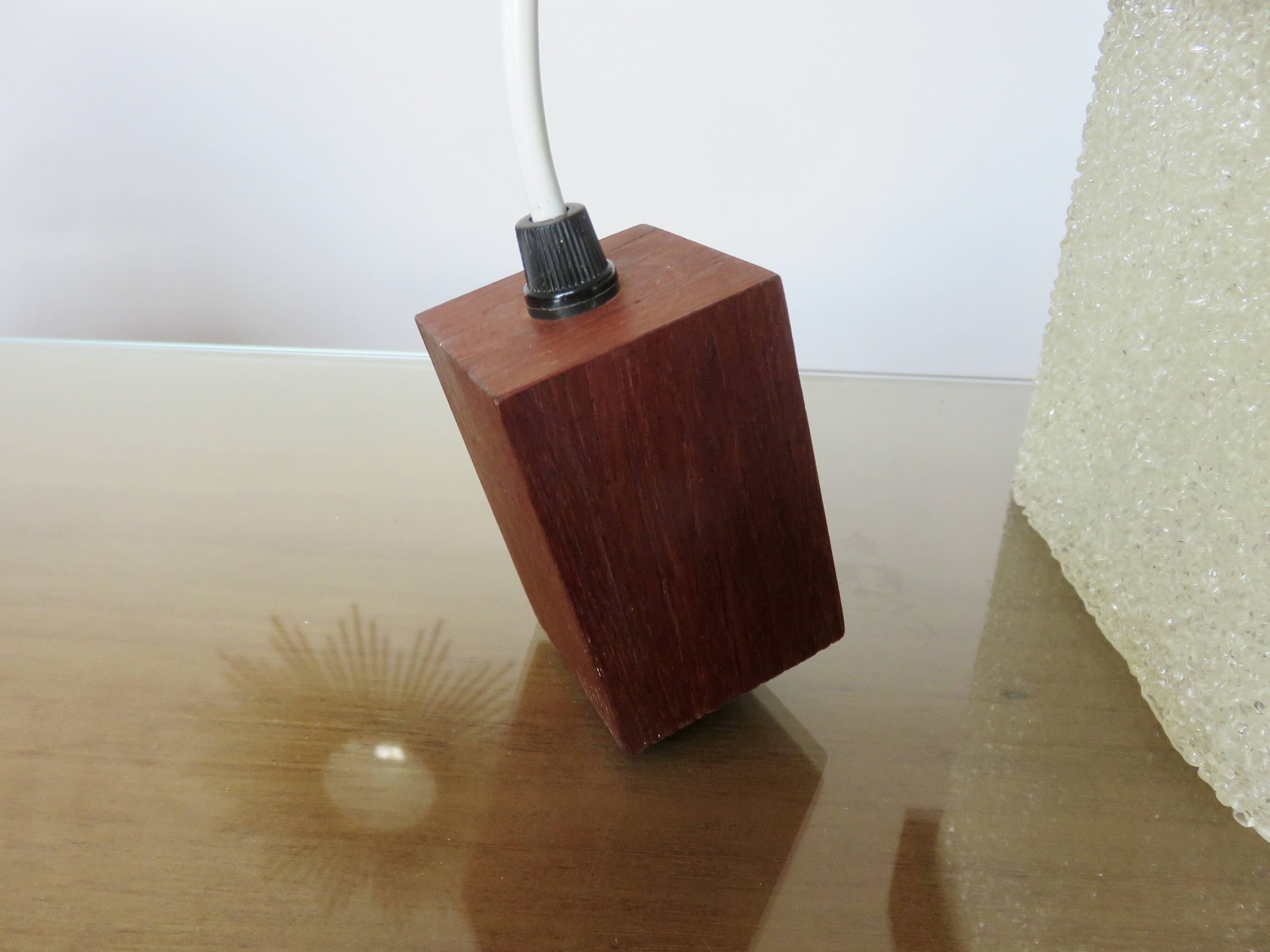 Pair of Scandinavian pendant lights in teak and perspex, 1970s.