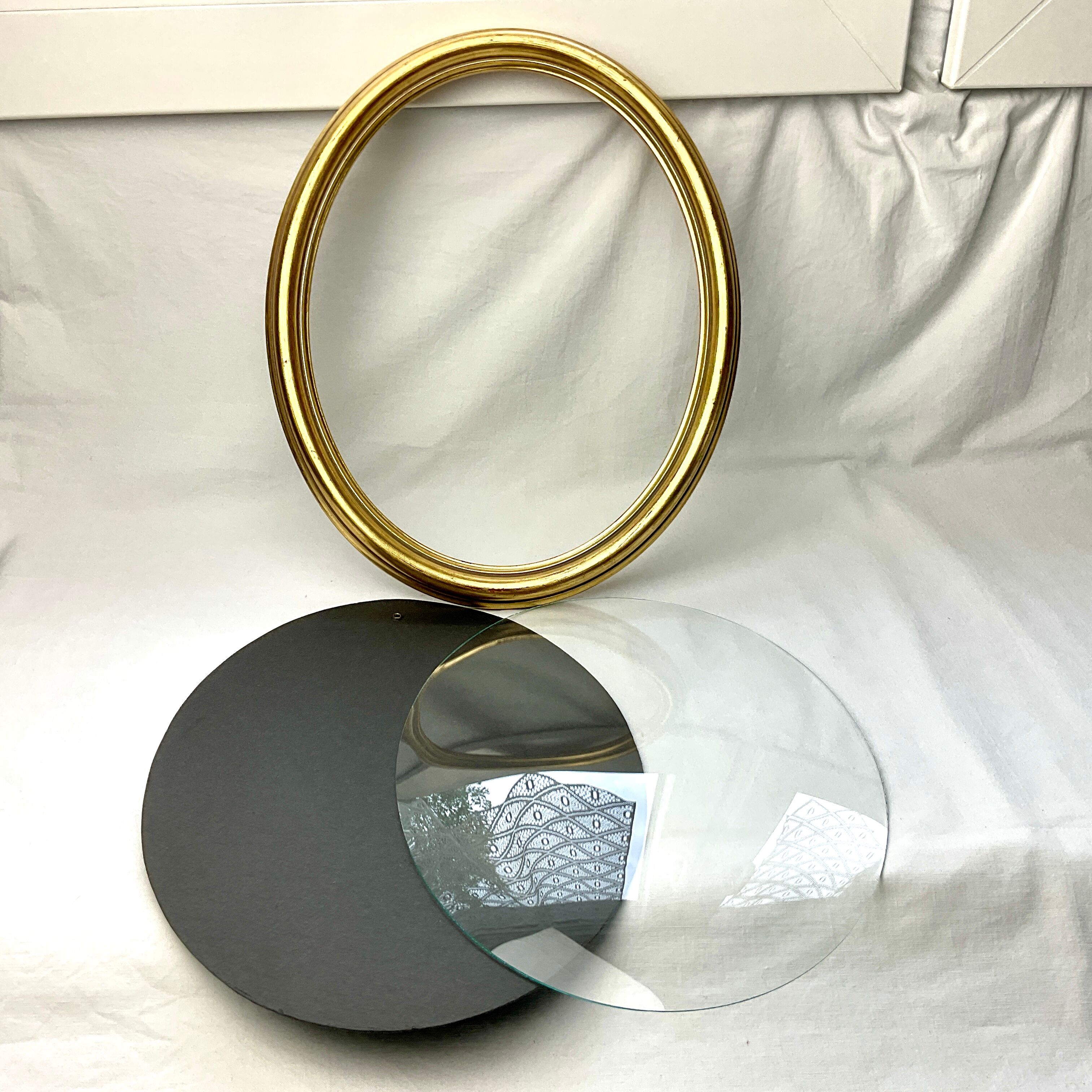 Old oval gilded wooden frame with domed glass