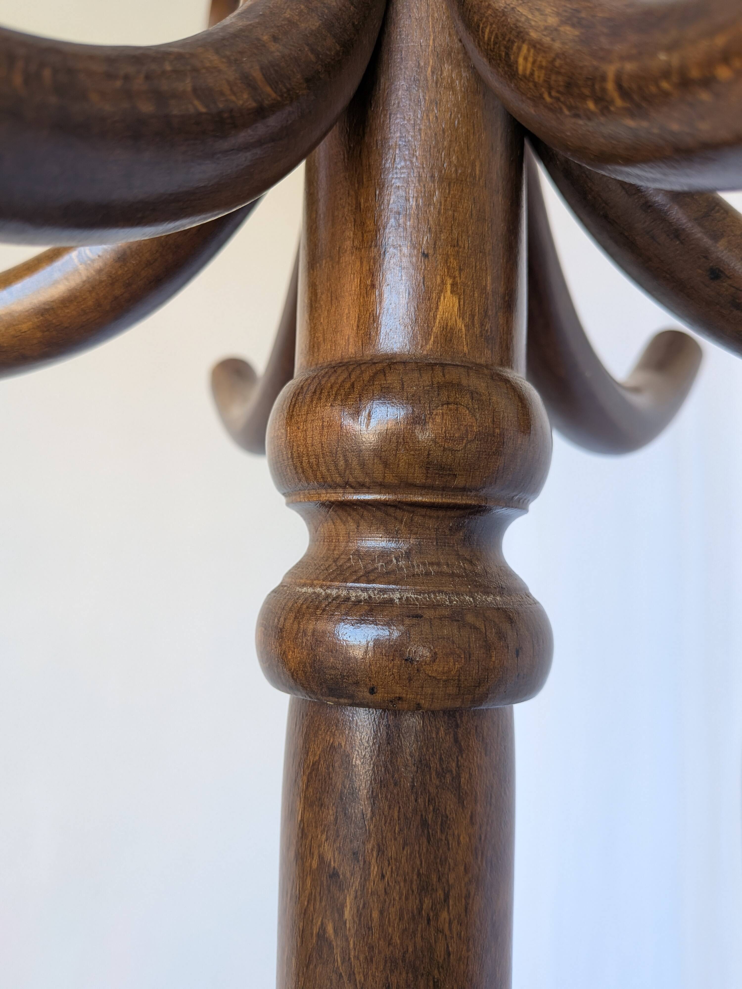 Vintage bentwood coat rack in Thonet style / Dark wood coat rack with shadow.
