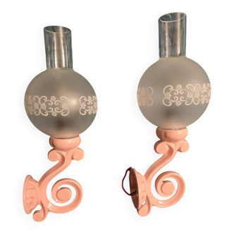 Original wall lights in pink enamelled cast iron with frosted glass globes.