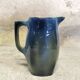 Blue glazed ceramic pitcher