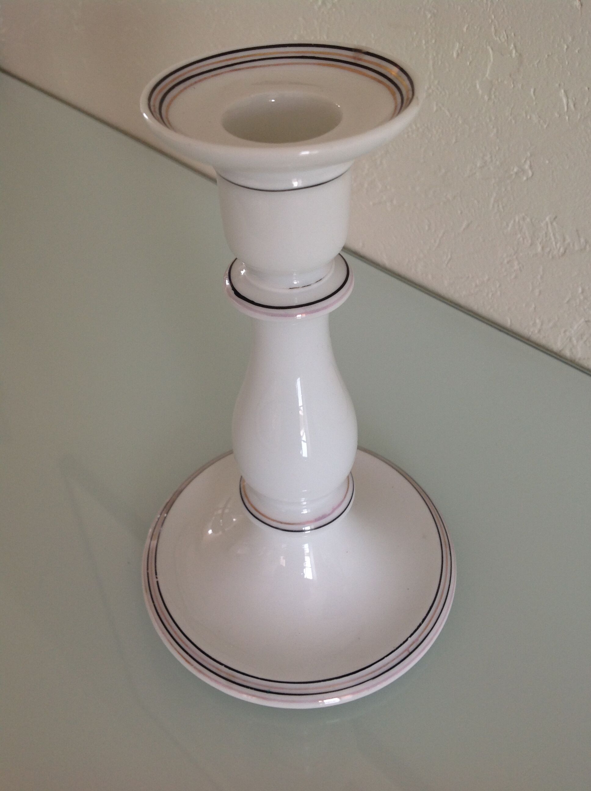 Old white earthenware candlestick