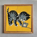 Wooden frame puzzle from the 1940s/50s depicting a cat on a yellow background.