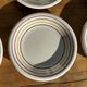 Set of 9 small Italian dessert plates Primula with red and green trim.