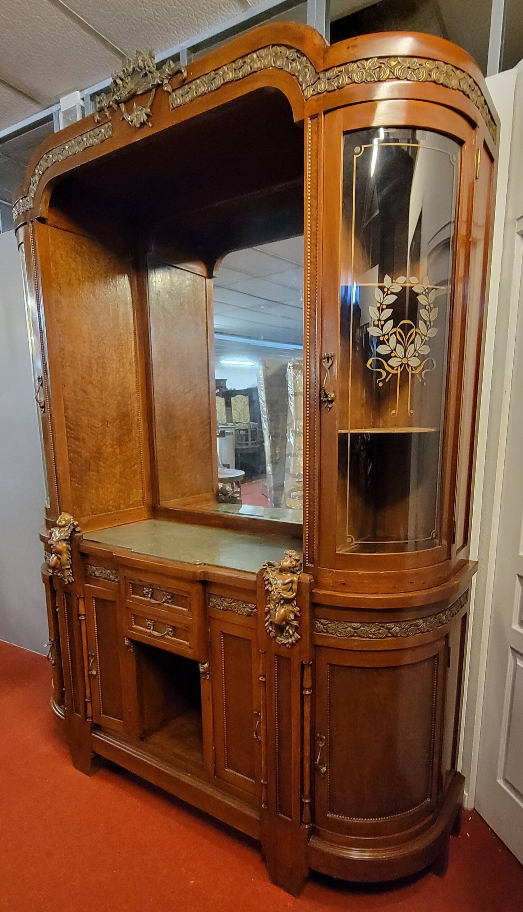 Empire style half-moon shaped mahogany bookcase with putti