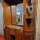 Empire style half-moon shaped mahogany bookcase with putti