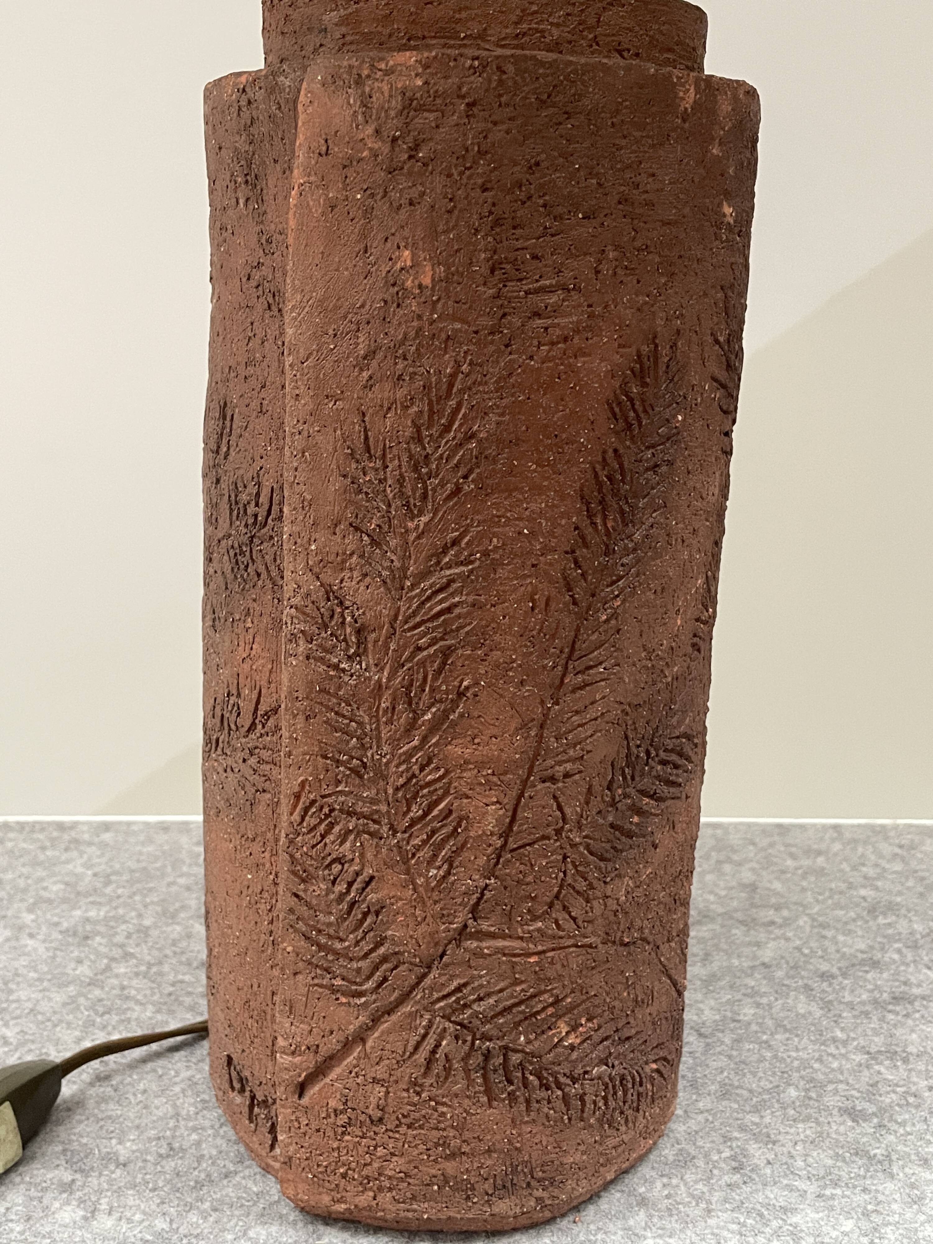 Large chamotte clay lamp in brutalist style, with a plant motif.