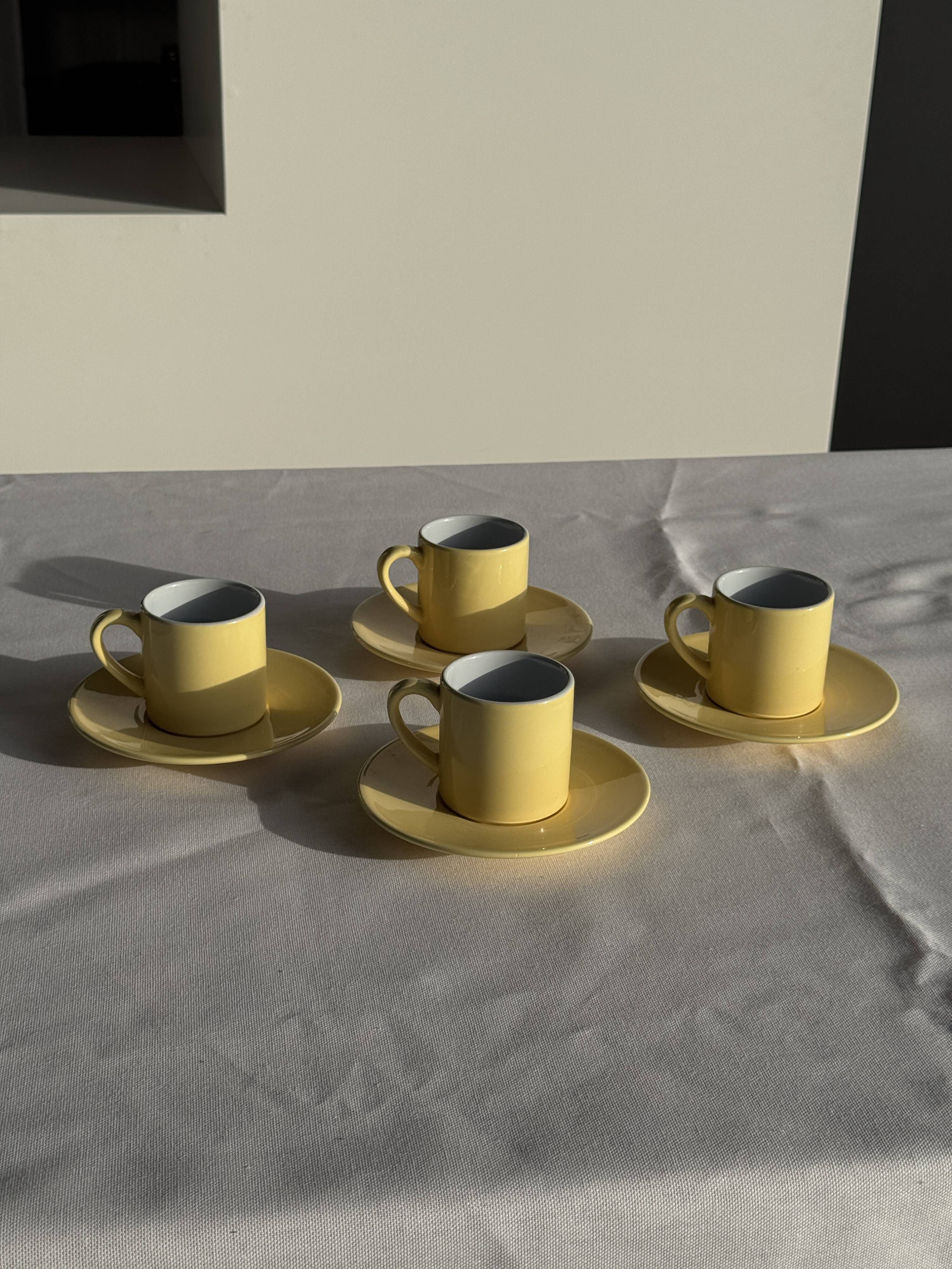 Set of 4 vintage yellow Italian espresso cups and saucers.