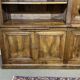 Library in walnut and oak from the early 20th century with its central clock.