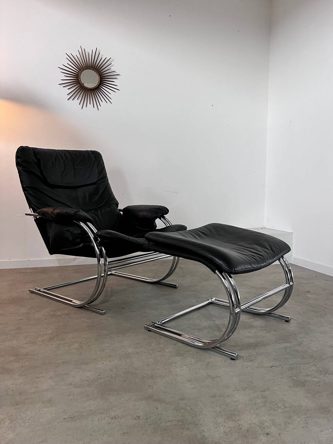 Old armchair and ottoman black leather tubular chrome bauhaus design from the 70s