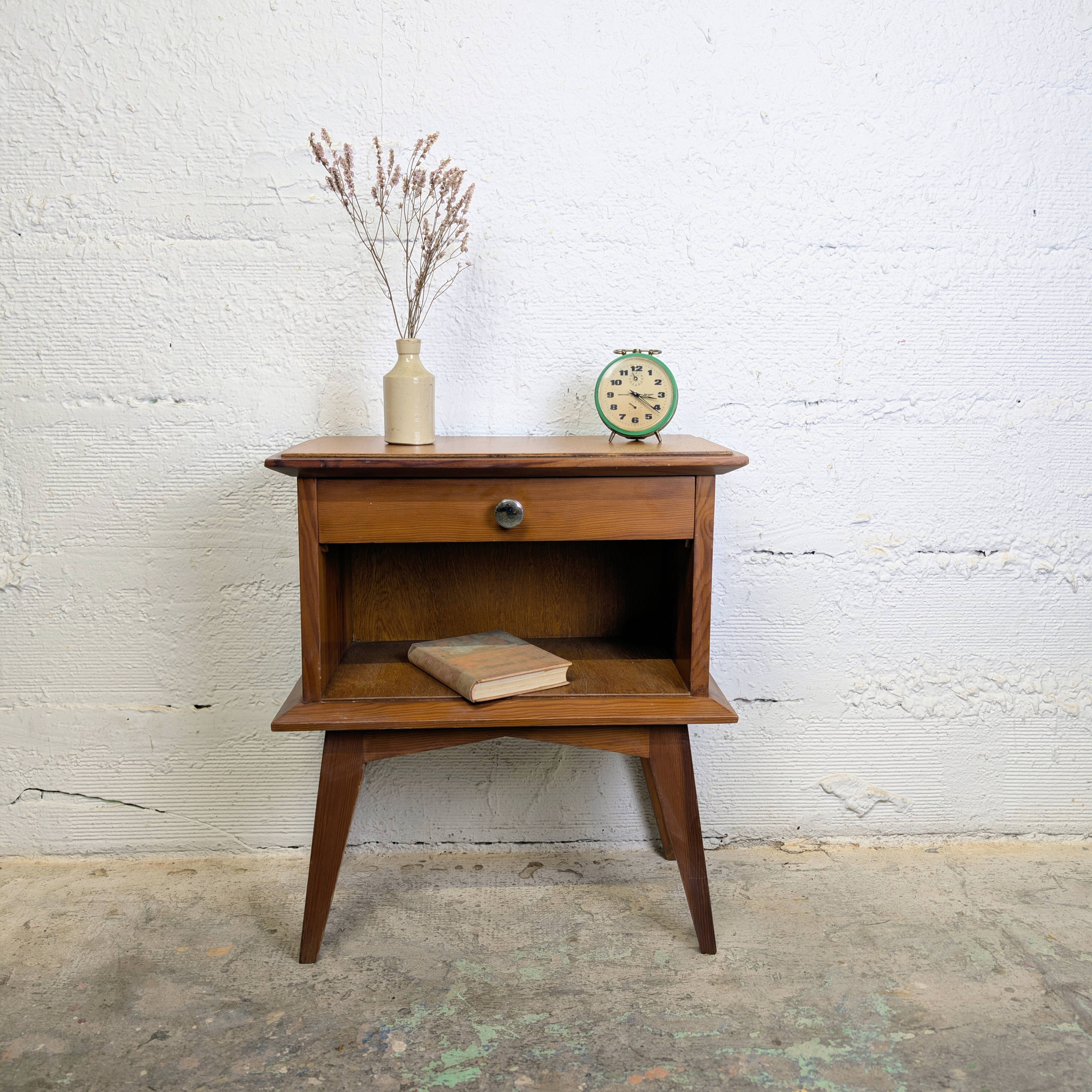 Vintage bedside table with tapered legs.