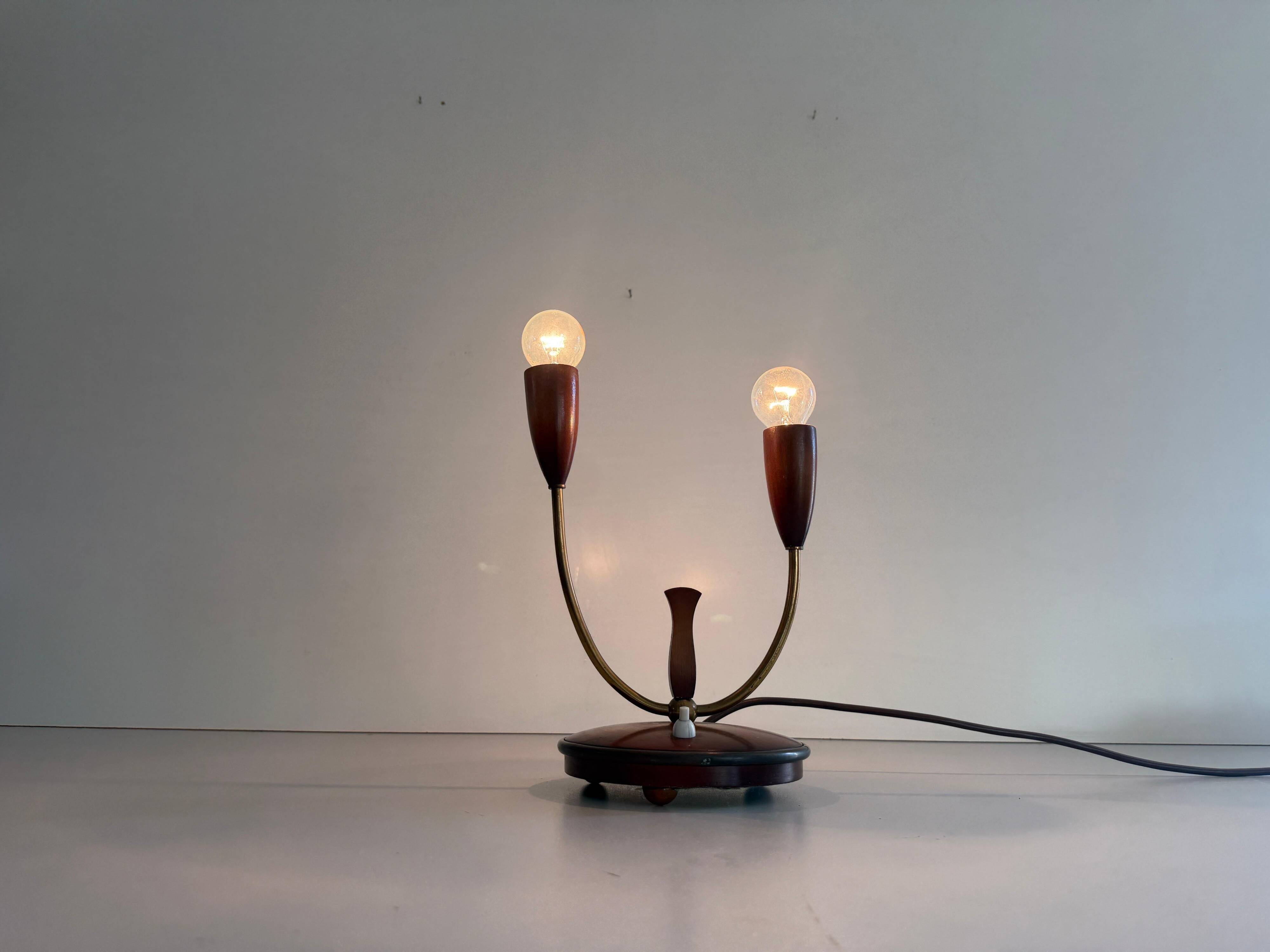 Simple double-headed table lamp in wood and brass, 1960s, Germany.
