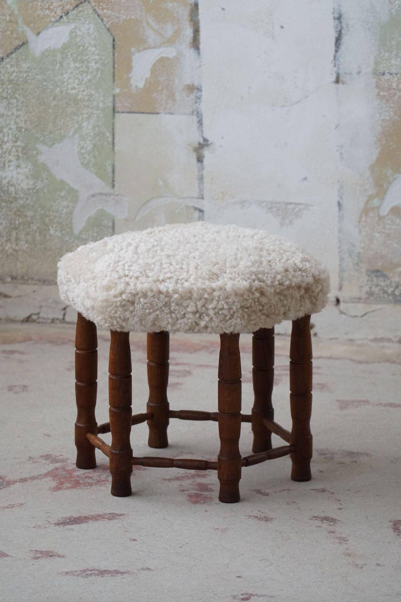 Modern Danish, a hexagonal oak stool, seat reupholstered in lambswool, 1950s.