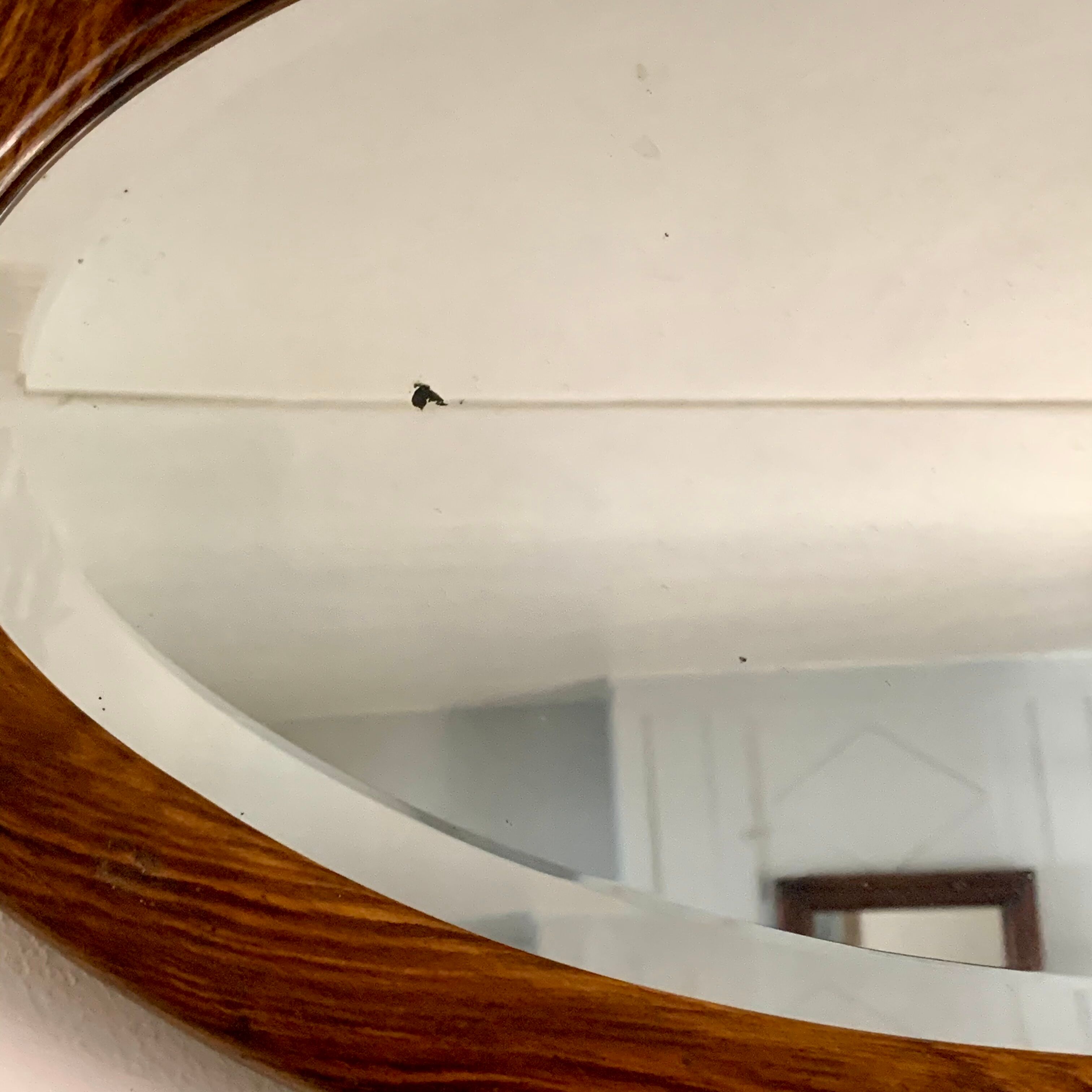 Oval wooden and stucco wall mirror