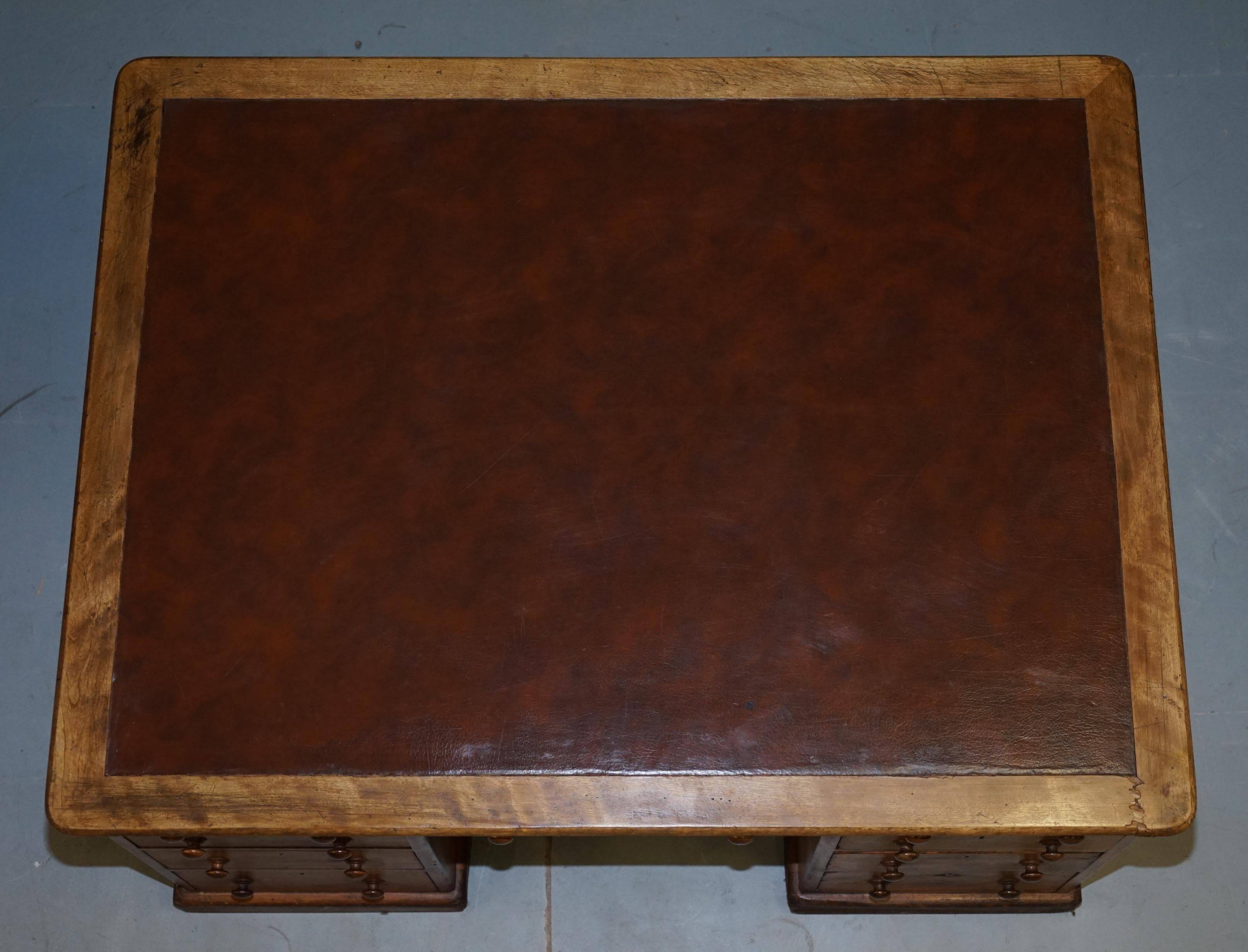Antique Victorian oak kneehole desk with 18 double-sided drawers.
