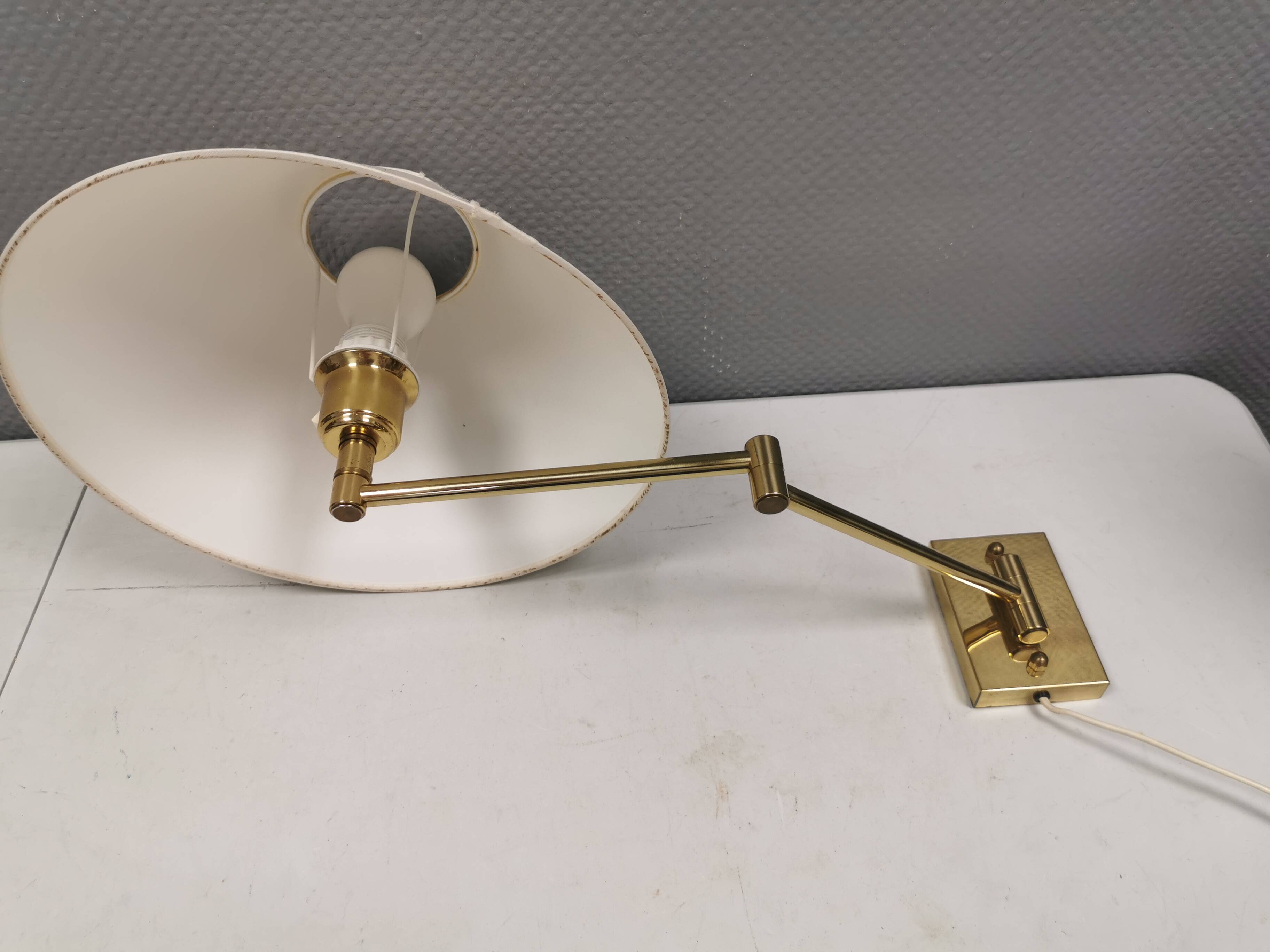 Danish Brass wall lamp with a ‘swivel’ effect.