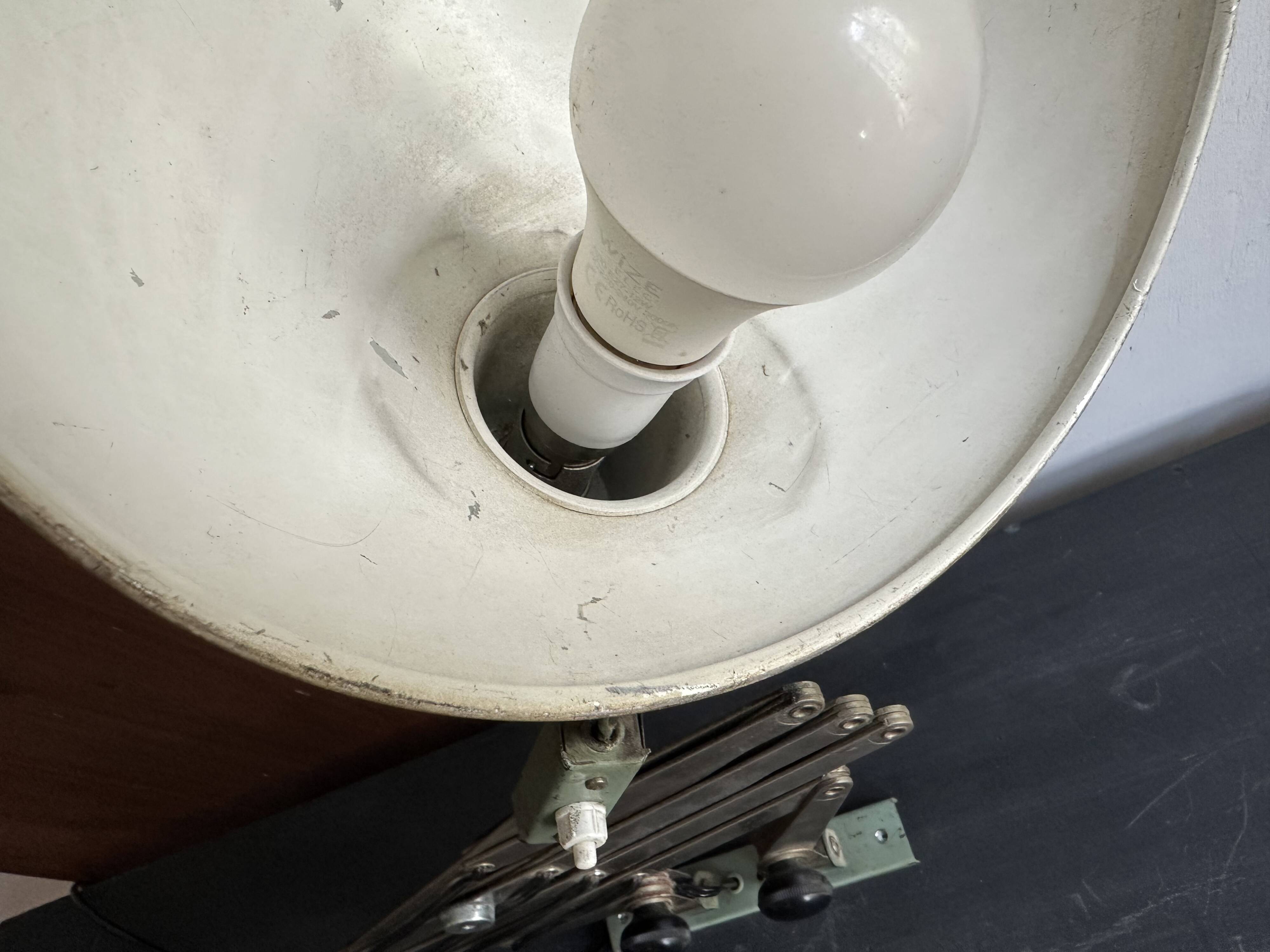 Old extendable accordion lamp in celadon green, workshop spirit.