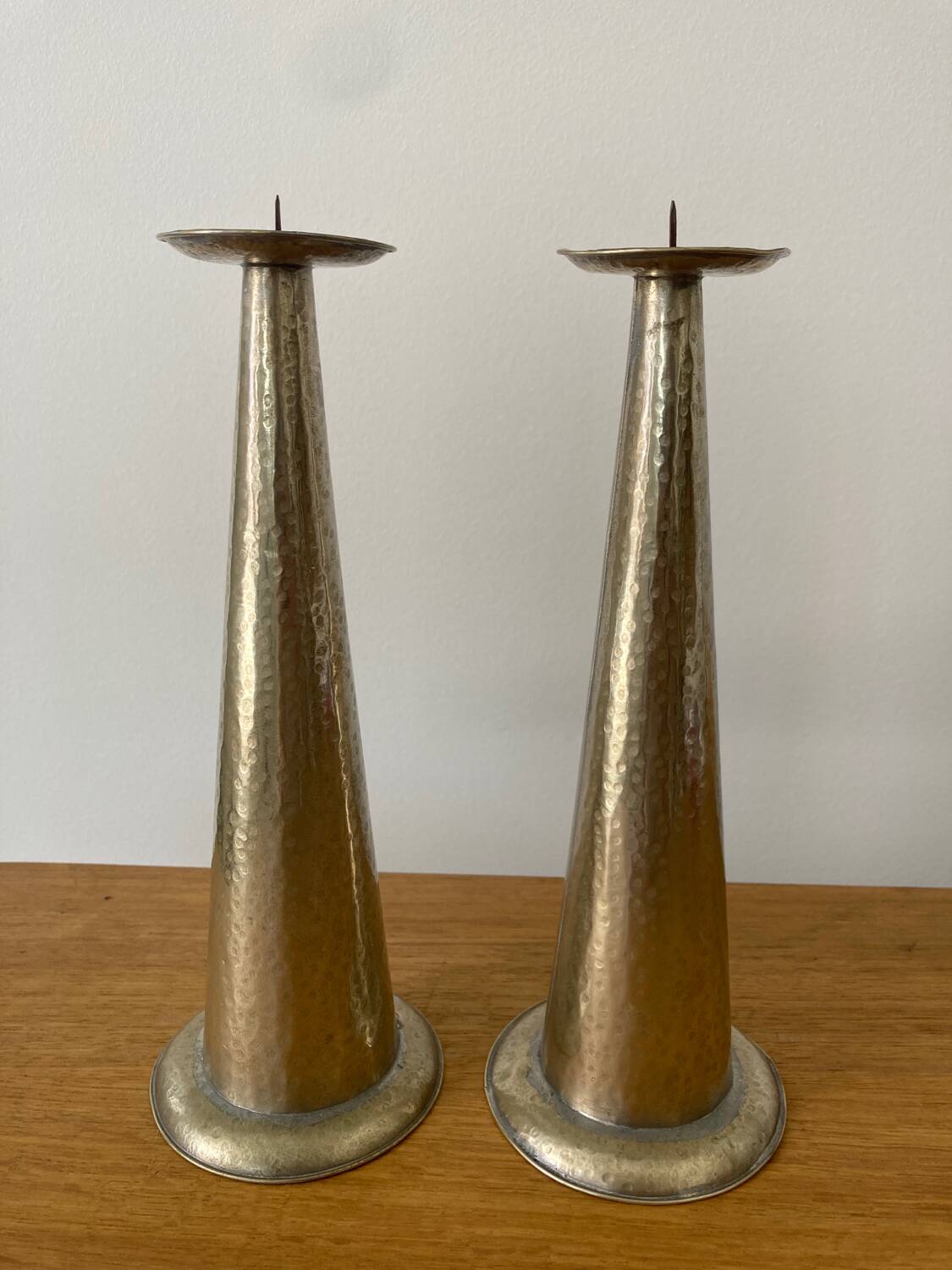 Pair of hammered metal candlesticks