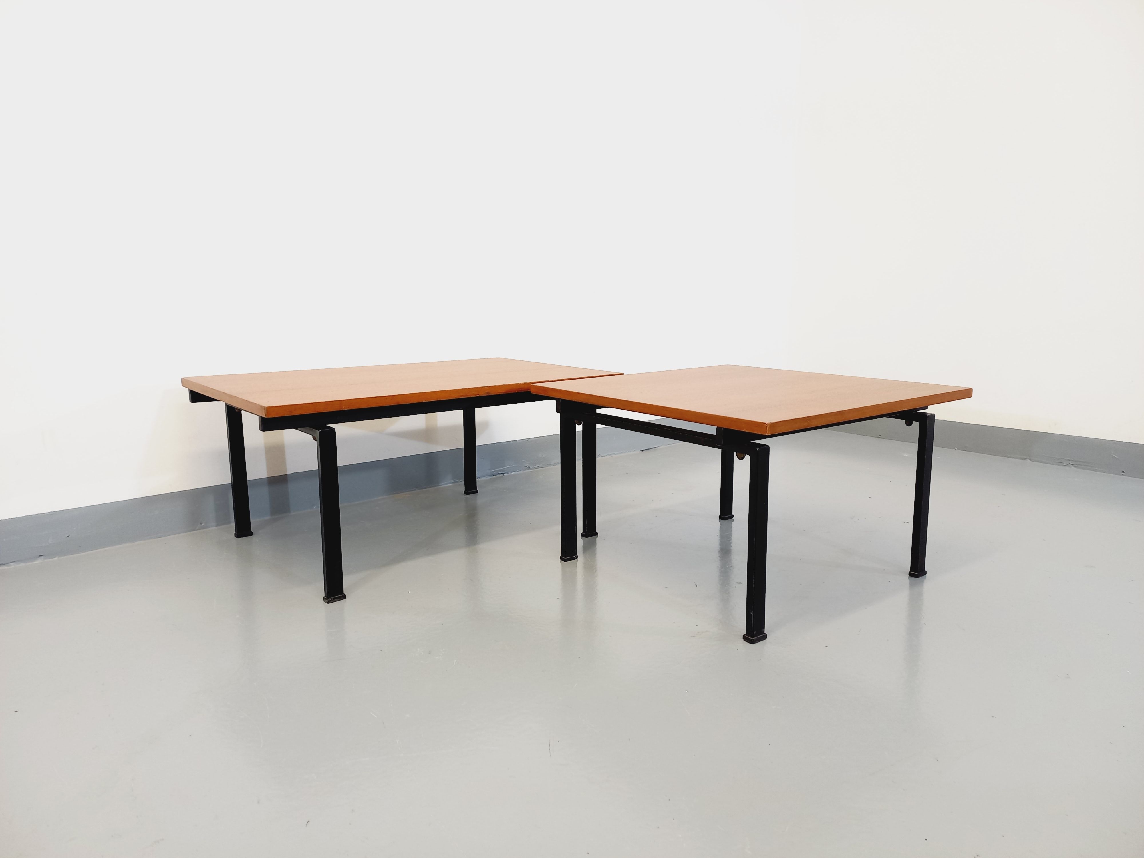Suite of two vintage modernist Isa coffee tables in teak and black metal from the 60s