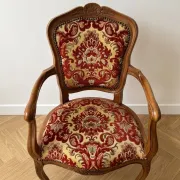 Louis XV style armchair in solid wood with red and gold damask fabric.