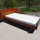 Vintage bed in teak with integrated bedside table.