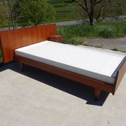 Vintage bed in teak with integrated bedside table.