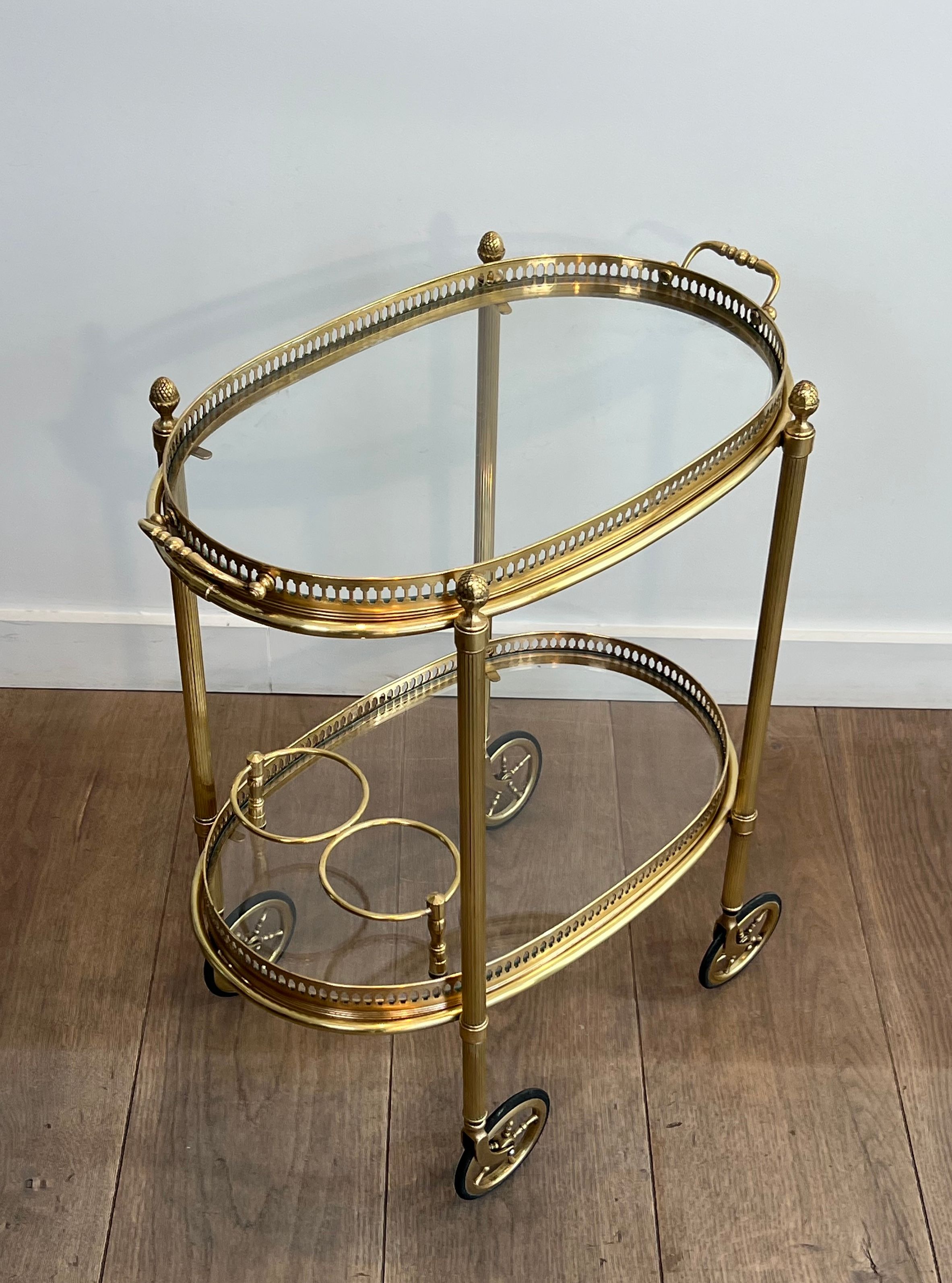 Small oval rolling table in brass with double removable trays from Maison Bagués.