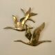 Birds in brass flight