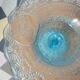 Plate on blue glass pedestal