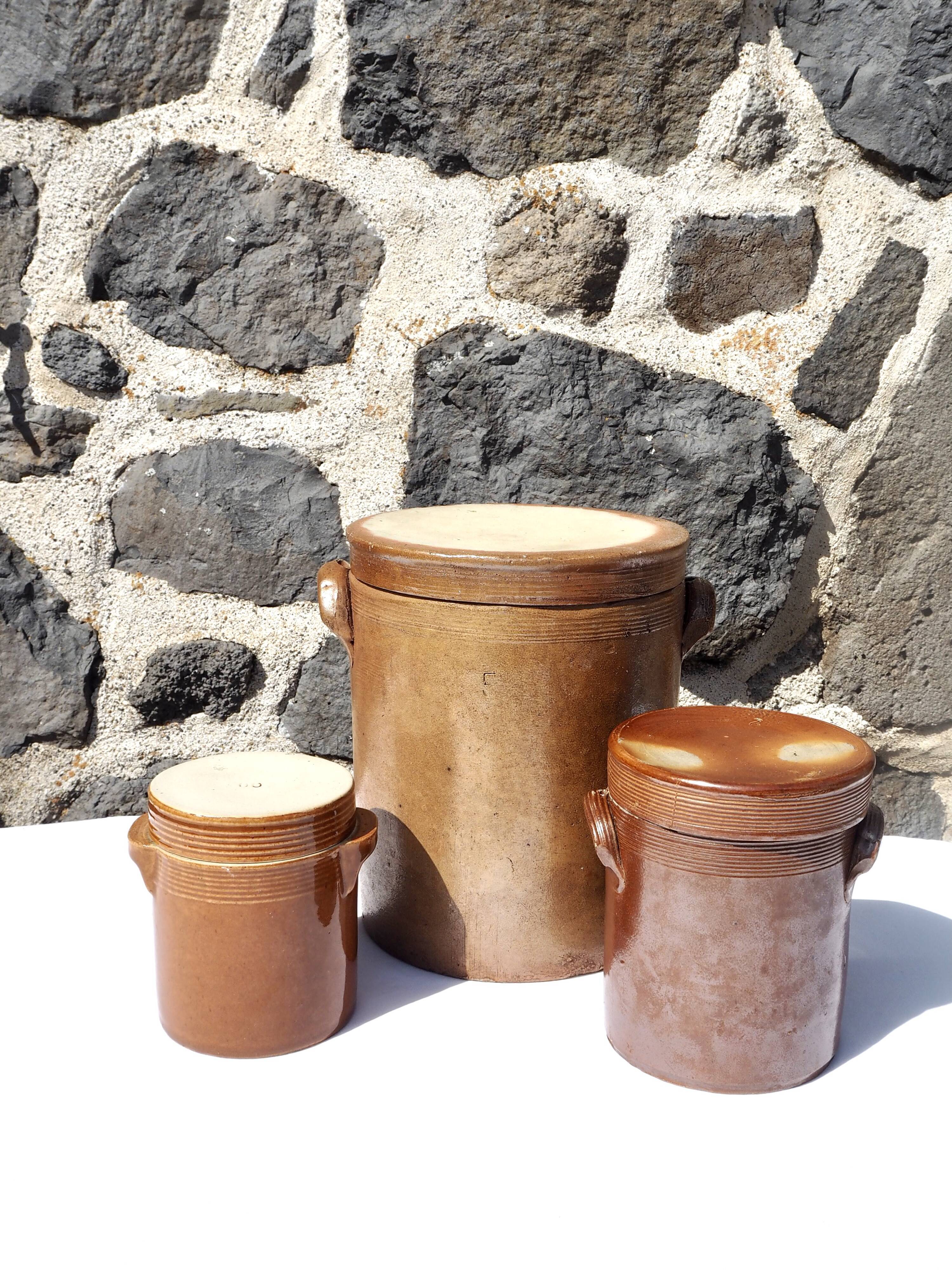 Trio of stoneware pots with lids