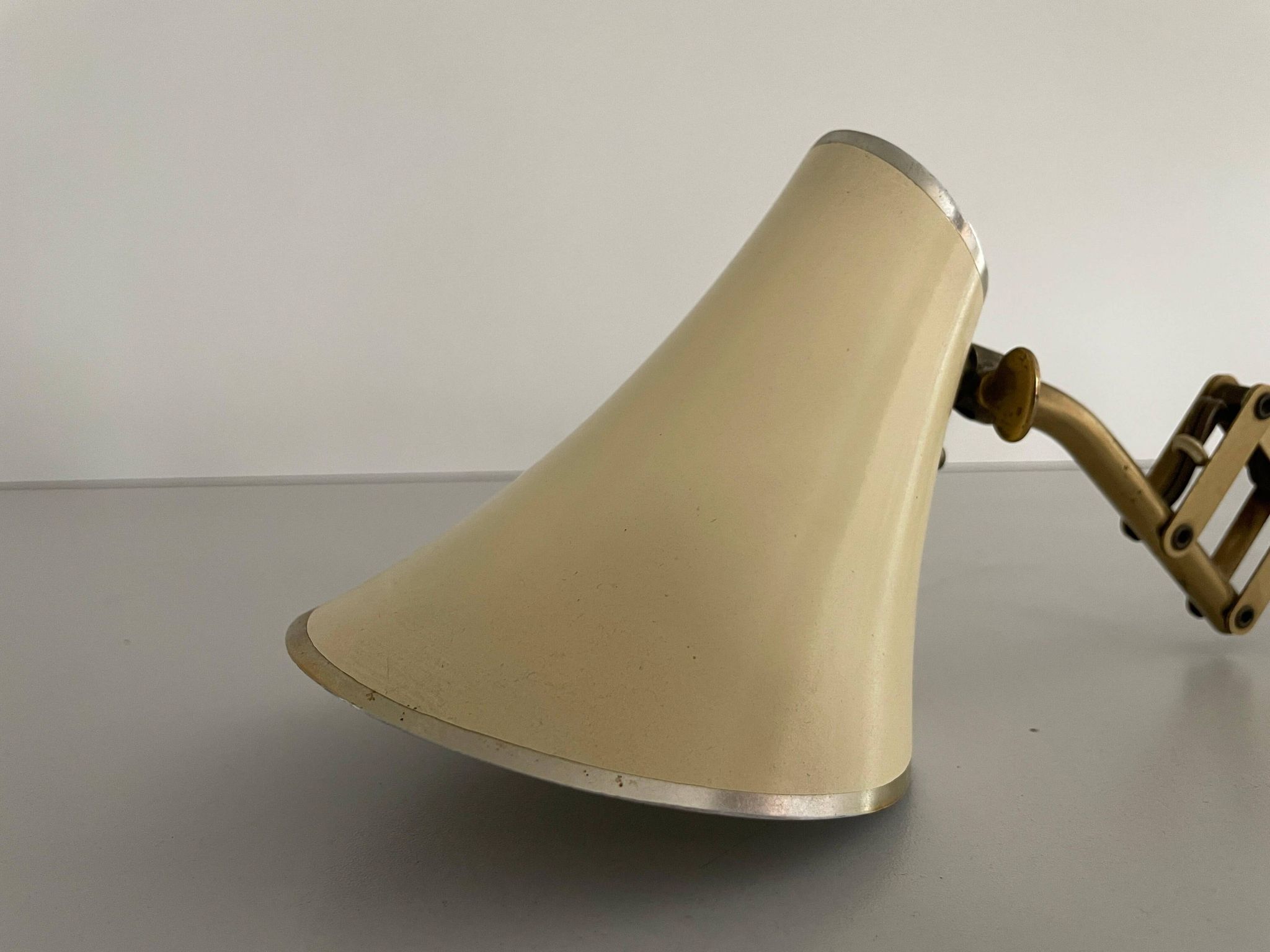 Cream metal and brass wall lamp with scissors design by Karl Lang for SIS Licht, 1950s, Germany.