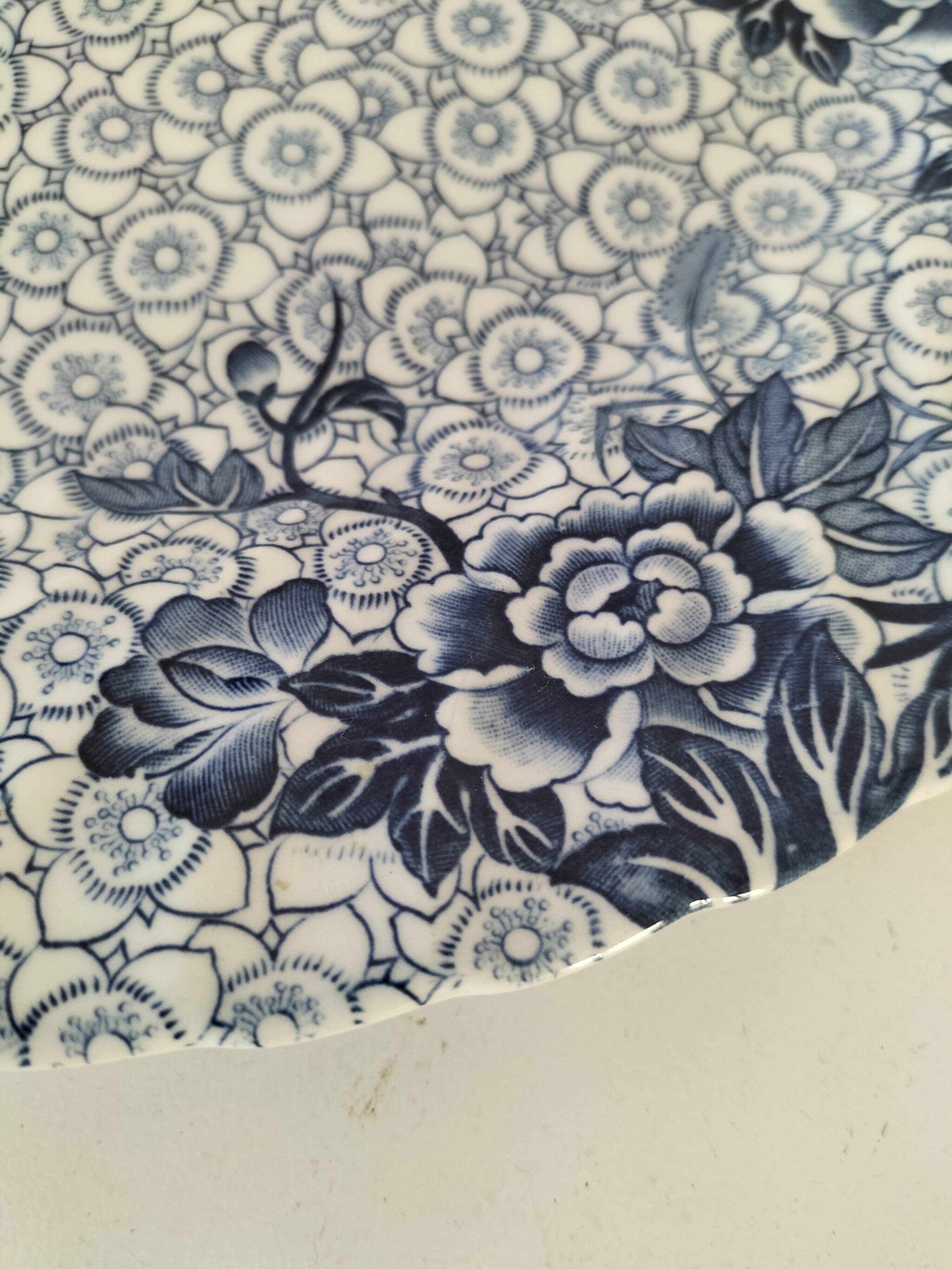 Round antique plate by Johnson Brothers in the Blue Lotus pattern.