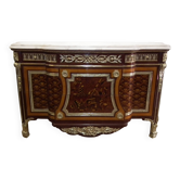 A Louis XV style sideboard with white marble top, adorned with bronze, and five drawers.