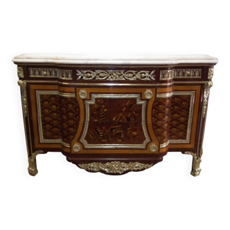 A Louis XV style sideboard with white marble top, adorned with bronze, and five drawers.