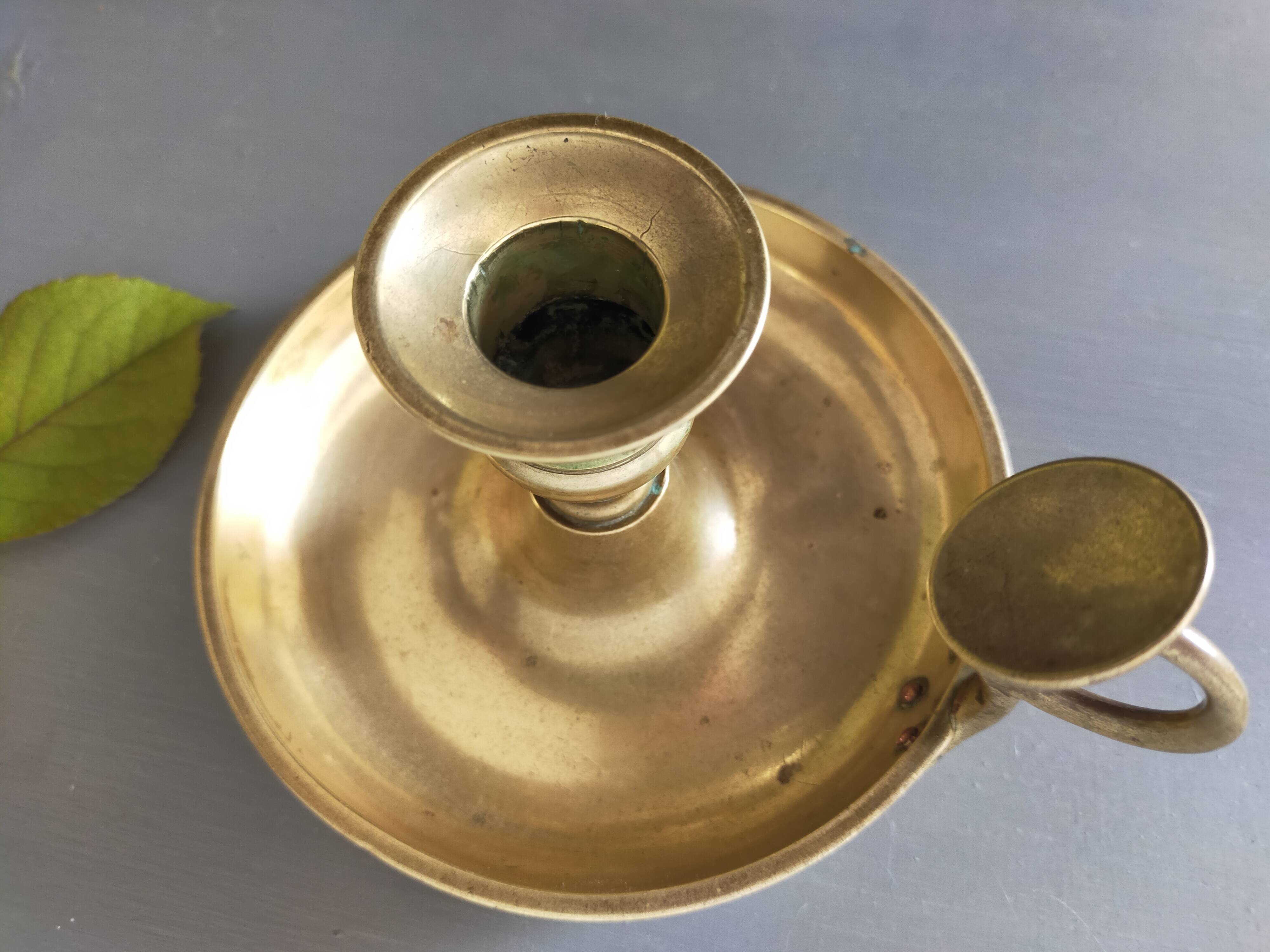 brass candle holder with old cellar rat thumb
