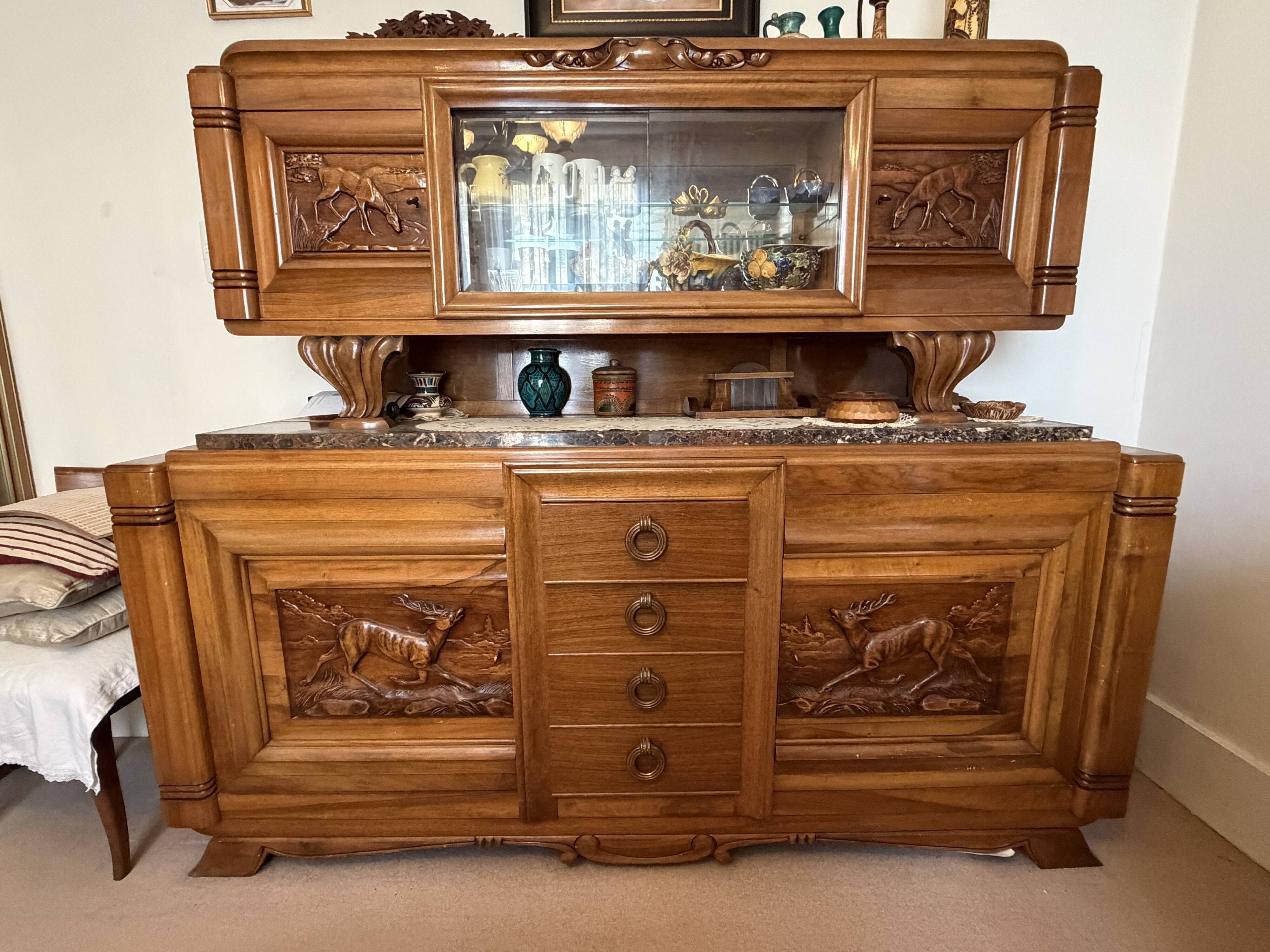 Solid wood sideboard with marble top and carved panels.