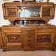 Solid wood sideboard with marble top and carved panels.