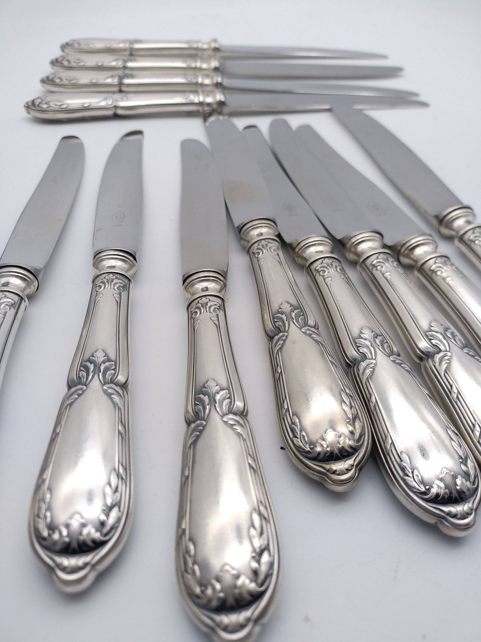Set of 12 sfam knives in silver metal and stainless steel blades.